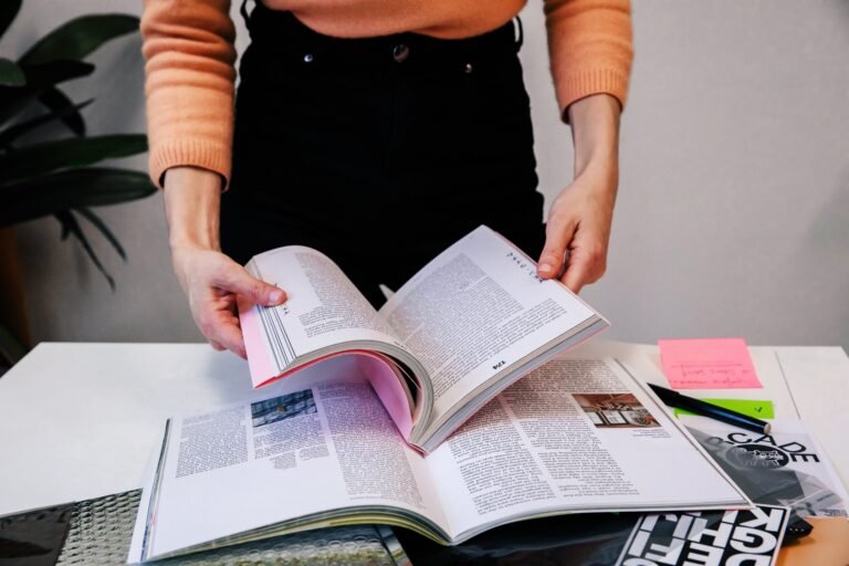 woman in office holding an opened book