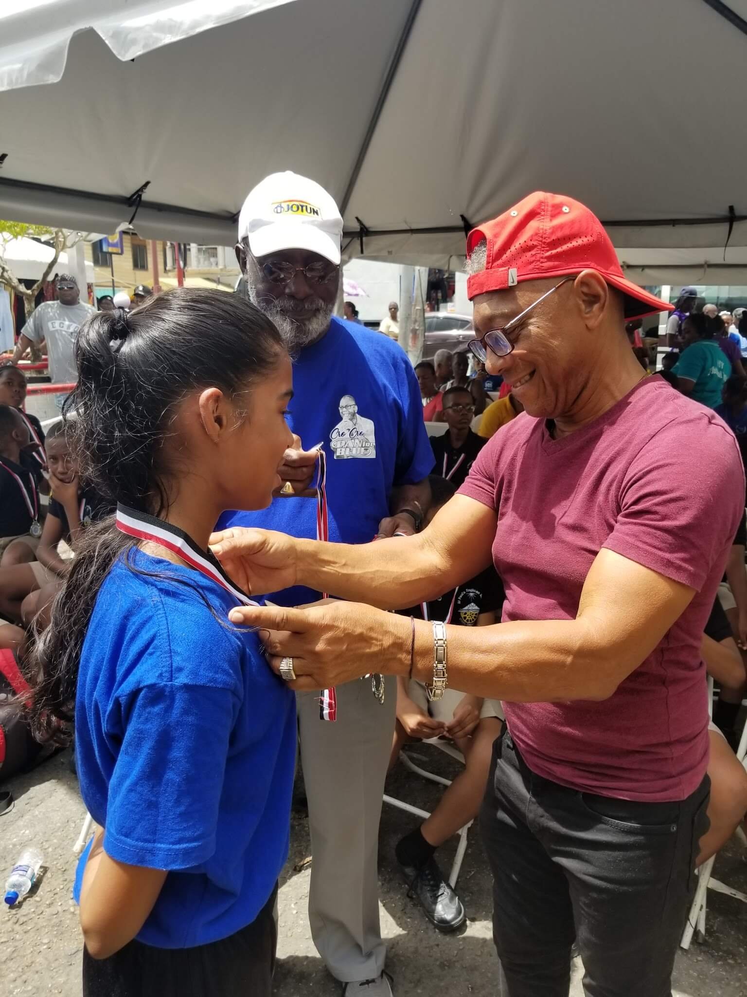 pan for blue event steelband player receiving medal from cro cro