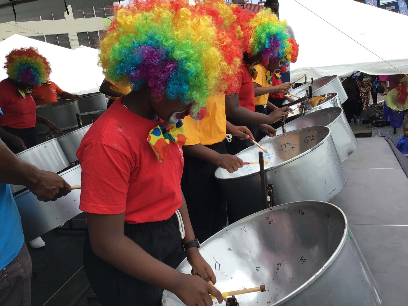 pan for blue primary school front line steel band players with colorful headpiece