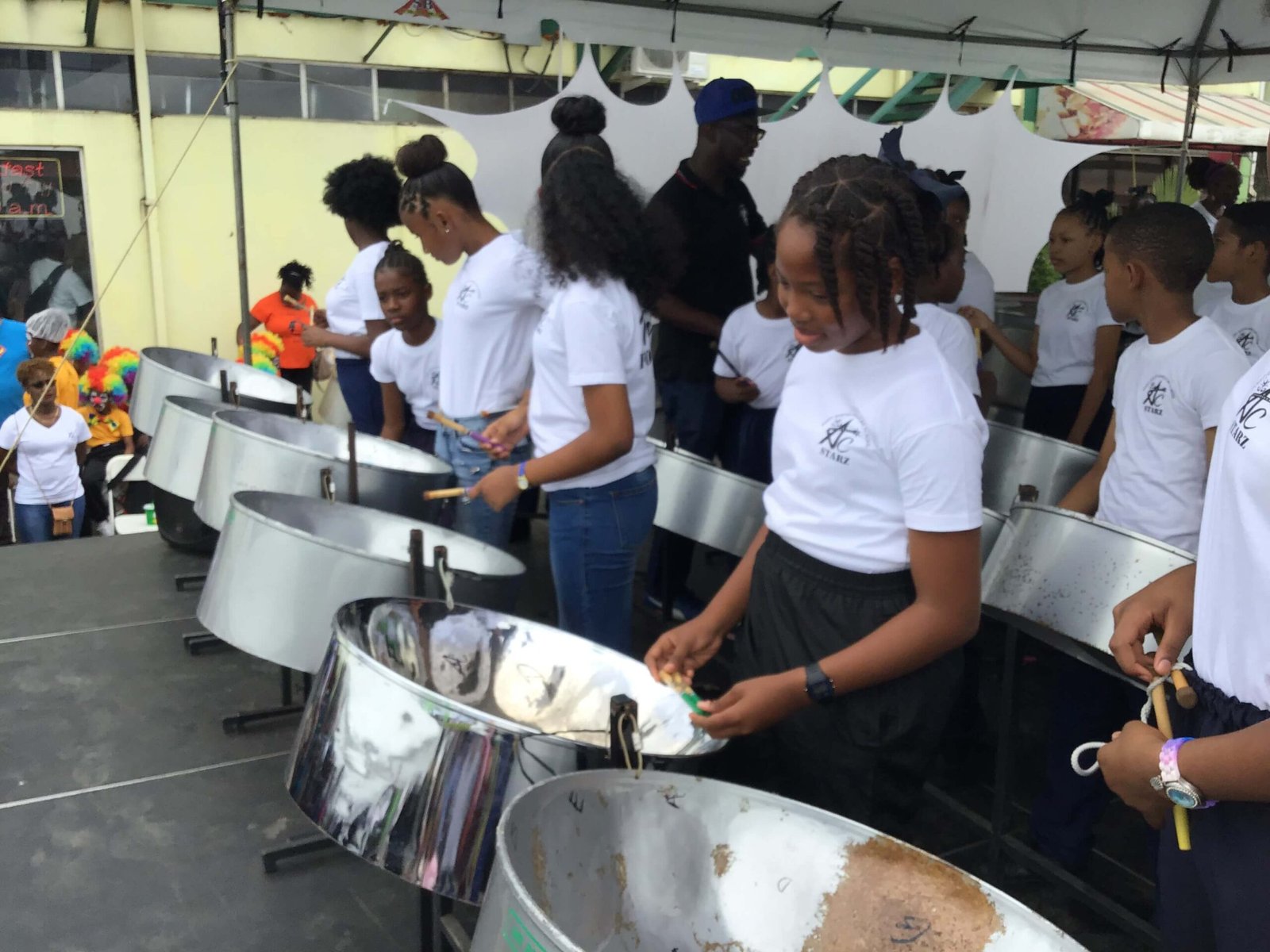 pan for blue primary school steelband players on stage