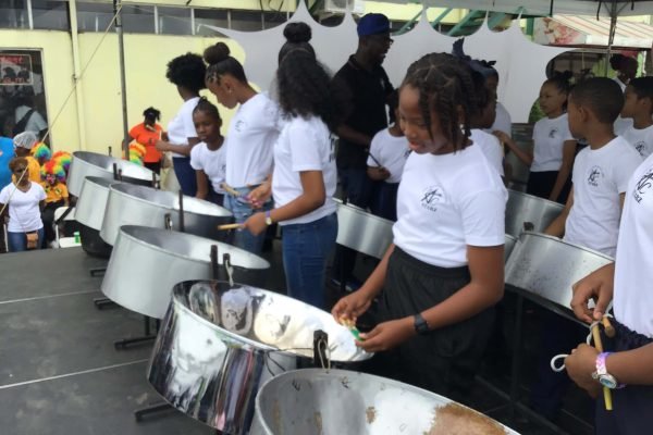 pan for blue primary school steelband players on stage