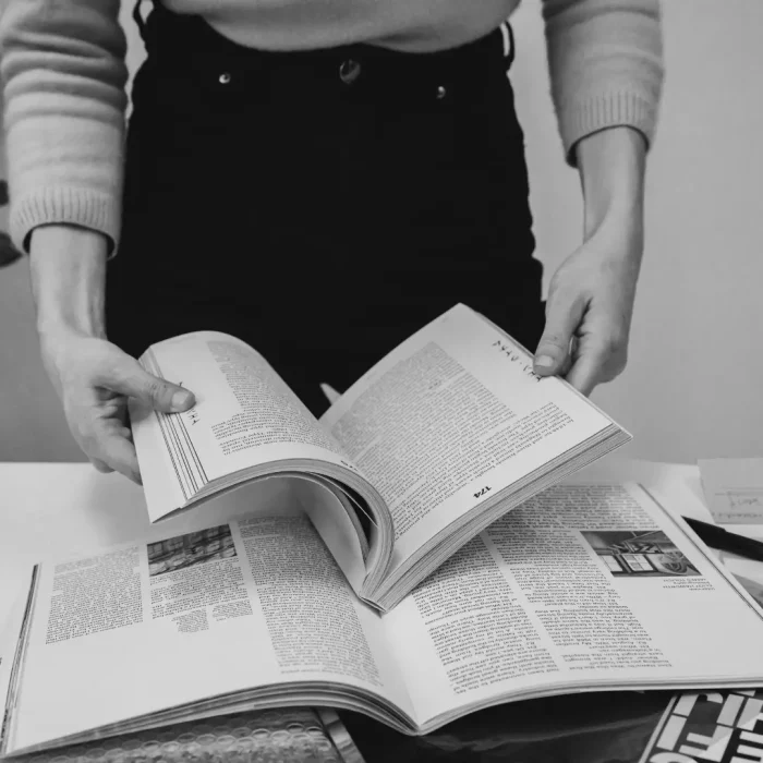 woman in office holding an opened book