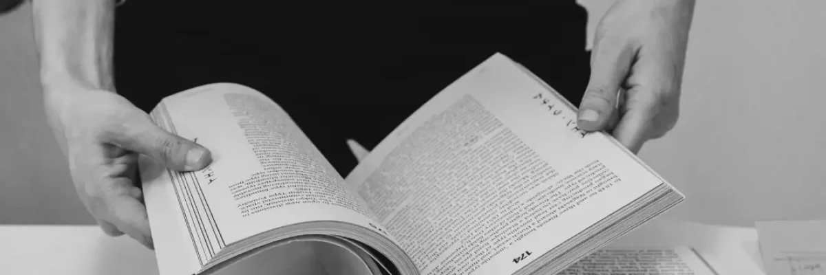 woman in office holding an opened book